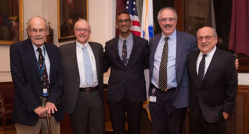 David Nathan, MD (left), Vijay Sankaran, MD, PhD (center), and Stuart Orkin, MD (right), with George Daley, MD, PhD (next to Nathan), and Len Zon, MD (next to Orkin) at a ceremony granting Dr. Sankaran an endowed professorship at Boston Children’s Hospital.