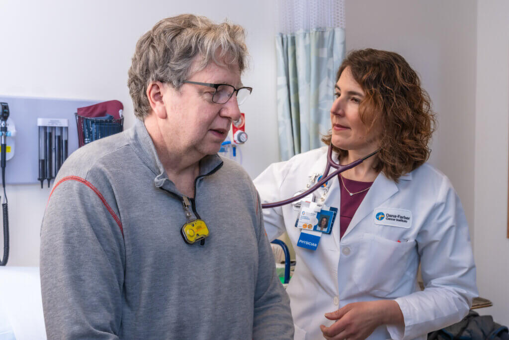 Elizabeth Buchbinder, MD, discussing TIL therapy with a patient.